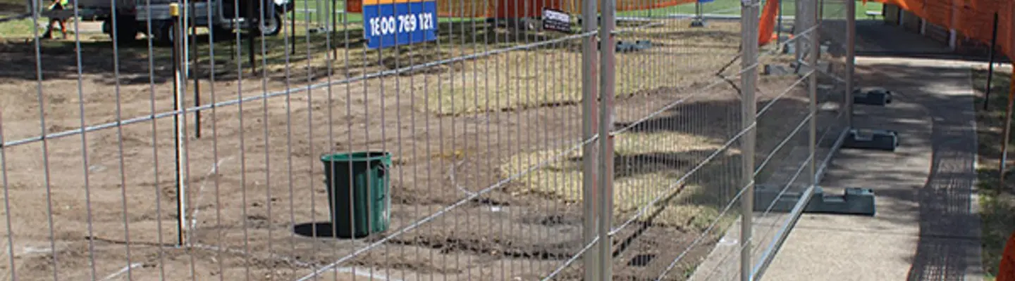 Temporary fencing installed around an active work area to restrict access and enhance on-site safety for workers and visitors.