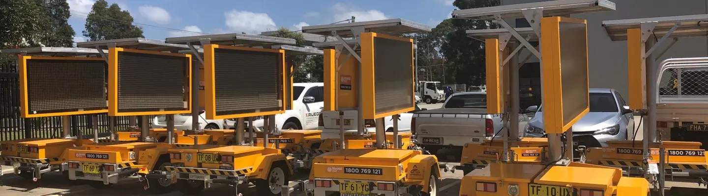 Construction equipment on display with a safety sign board mounted on top, highlighting site regulations or warnings.