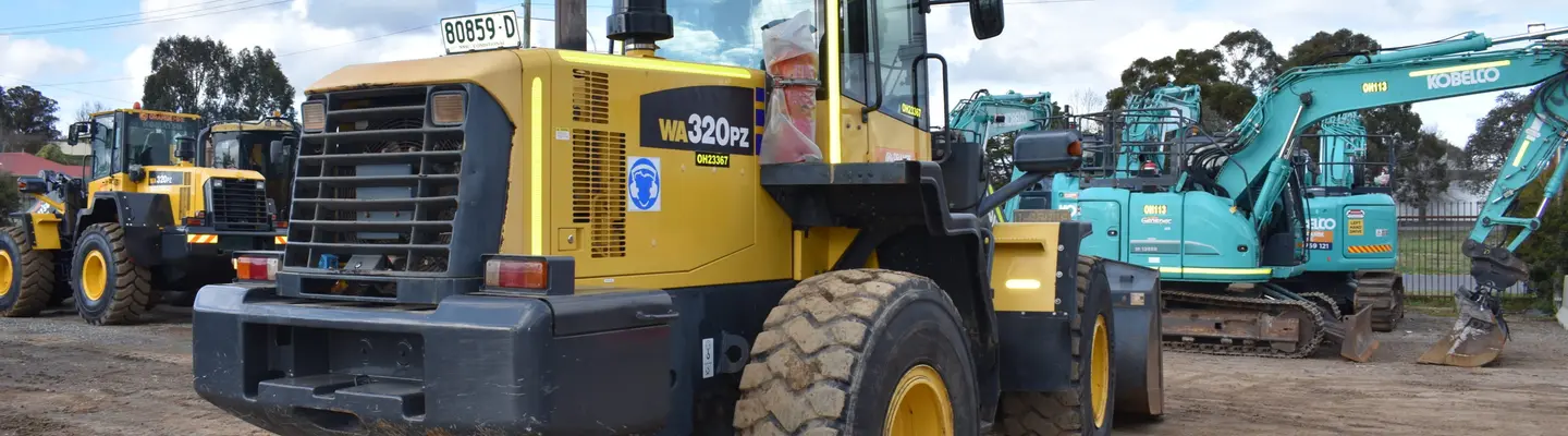 Various rental equipment neatly arranged outdoors, including construction tools and machinery ready for customer use.