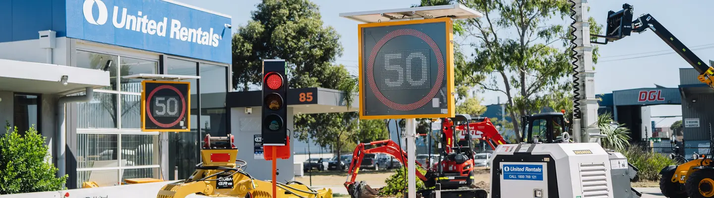 Traffic Management: A range of traffic management equipment that includes Tripod Mounted Traffic Lights, VMS Board – Variable Message Signs, Trailer Mounted Lighting Tower and Deltabloc Concrete Barriers (in the background).                                                                                                                                                                                     Barriers: Lo-Ro Water Filled Barriers stacked up at a United Rentals yard