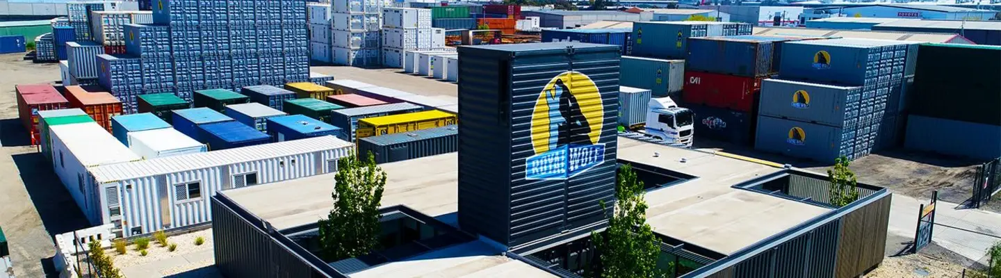 Newly acquired shipping containers lined up in a storage yard, cleaned and prepared for sale or delivery.