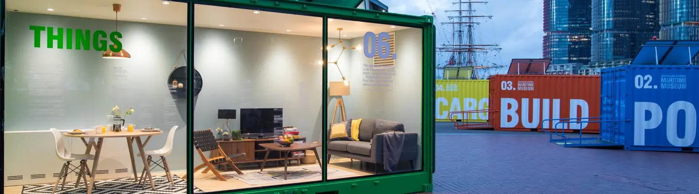  Exhibition space featuring shipping containers arranged creatively to display art or products in a modern, industrial setting.