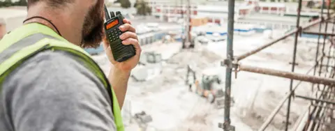 worker talking into radio