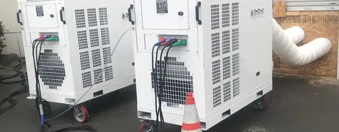 white temporary chiller systems outside a warehouse with ducting going in