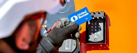 Worker tapping United Rentals card for access.