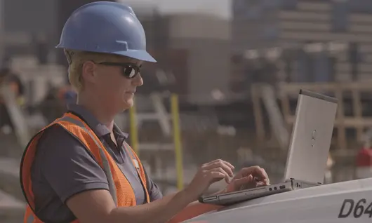 woman on jobsite with laptop