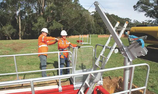 Workers installing edge protection equipment on a construction site to prevent falls and enhance site safety