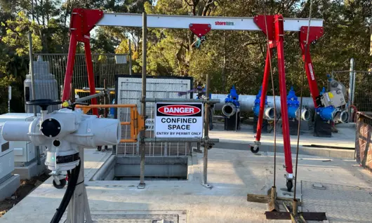 Construction site with various materials scattered and a warning sign indicating a dangerous confined space for safety awareness.