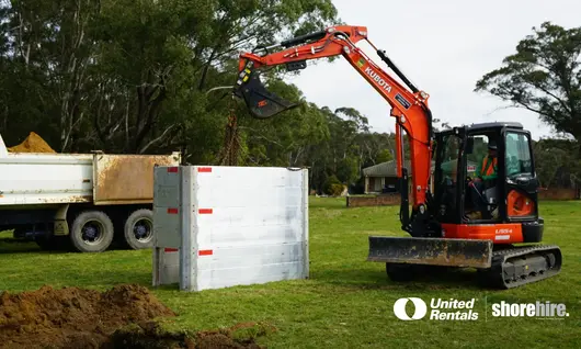 Modular Aluminium Panel Shields (MAPS) being carried with an excavator to be installed under ground